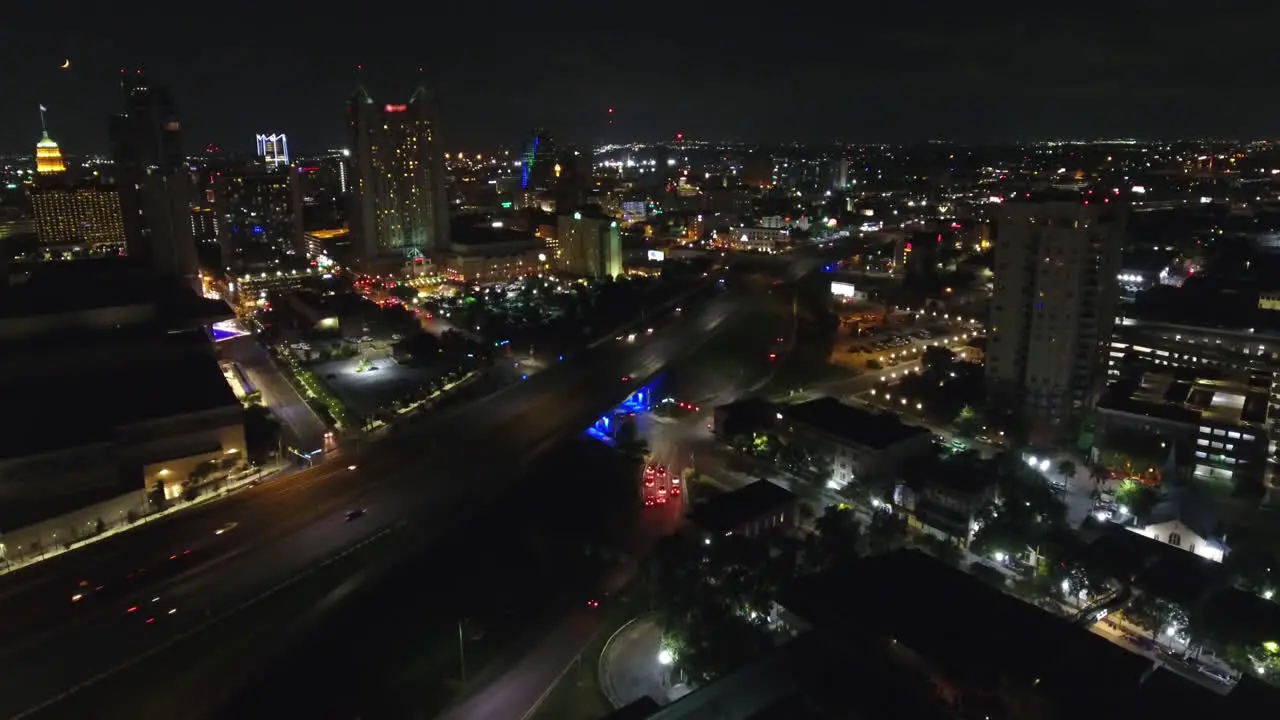 A nighttime aerial establishing shot of the city of San Antonio Texas