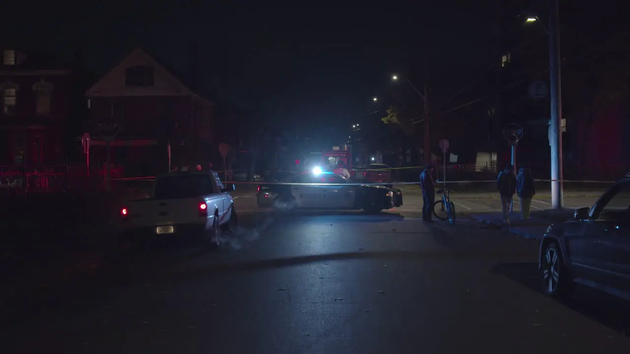 Police car blocking off road at night