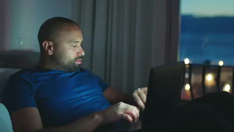 Tired man working at night time with laptop