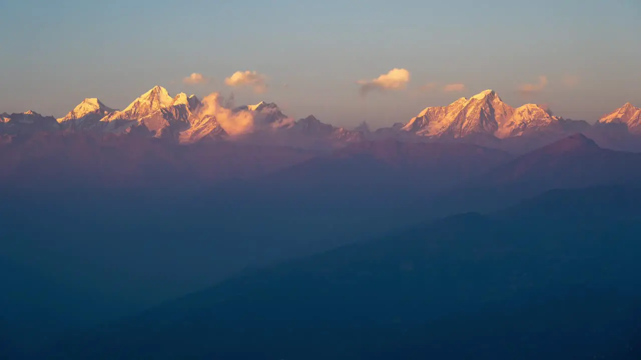 A time-lapse of the sun setting over the Himalaya Mountains with clouds passing by in the sky