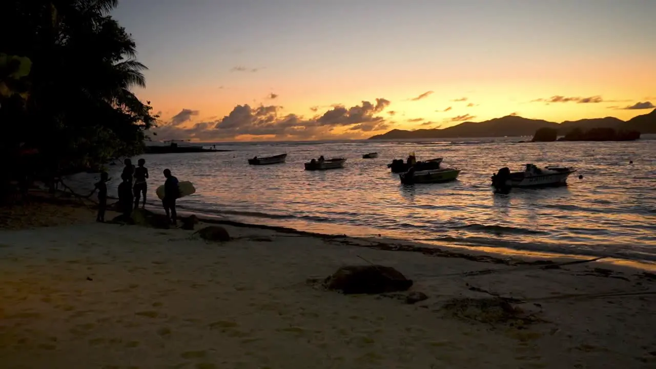 La digue seychelles sunset with boats anchored in shallow water