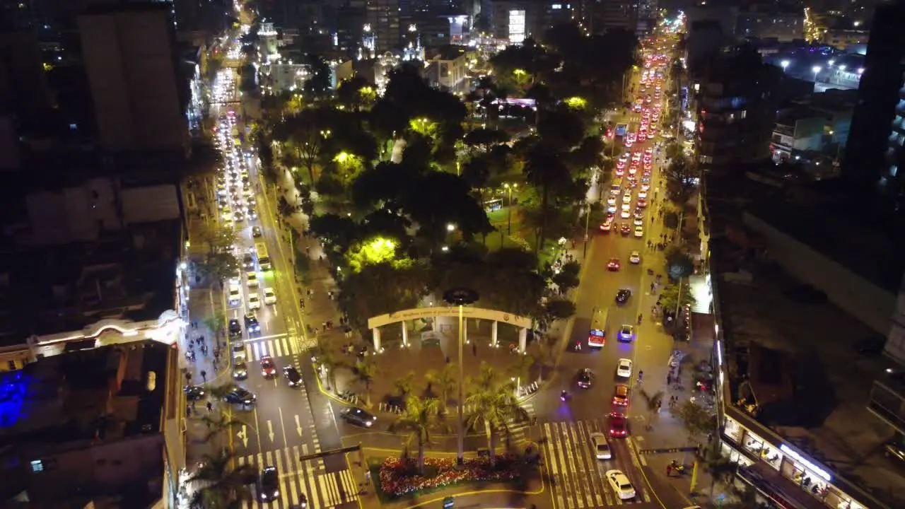 Drone 4k aerial video of night time Lima Peru of "Parque Kennedy" or "Kennedy Park" in Miraflores district