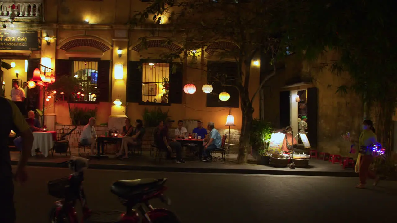 A tracking shot of a walking street vendor selling toys with blinking LED lights for children