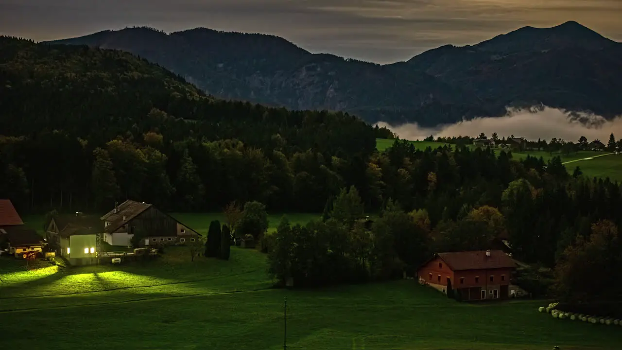 Village countryside valley with rolling mist at nightfall timelapse