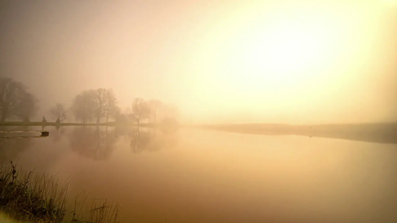 Time lapse transition dusk sunrise to clear sky night with stars of house near lake in rural area