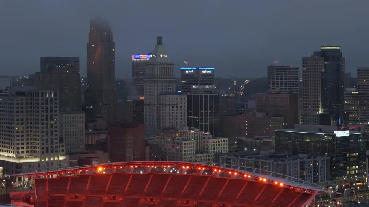 Aerial of Paycor Stadium overlooking US city Cincinnati at night Pan right