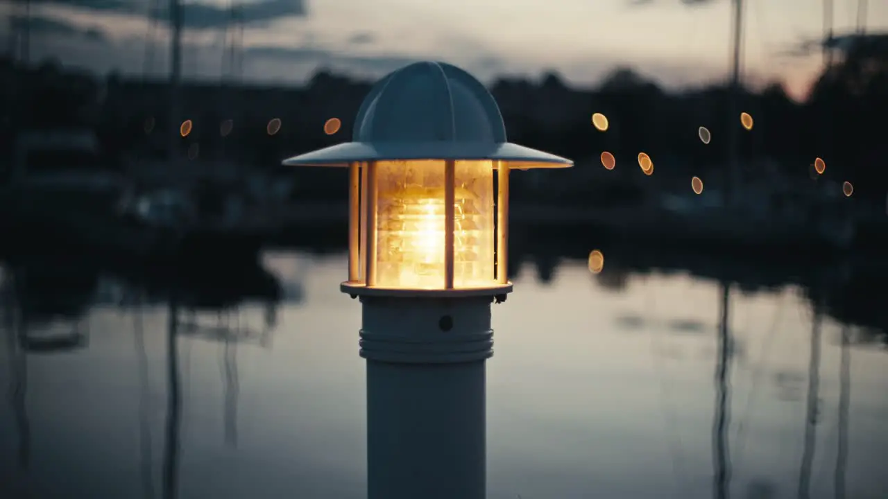 Marina Lamp at Night with Subtle Water Background Light Bokeh Dusk Reflections 4K