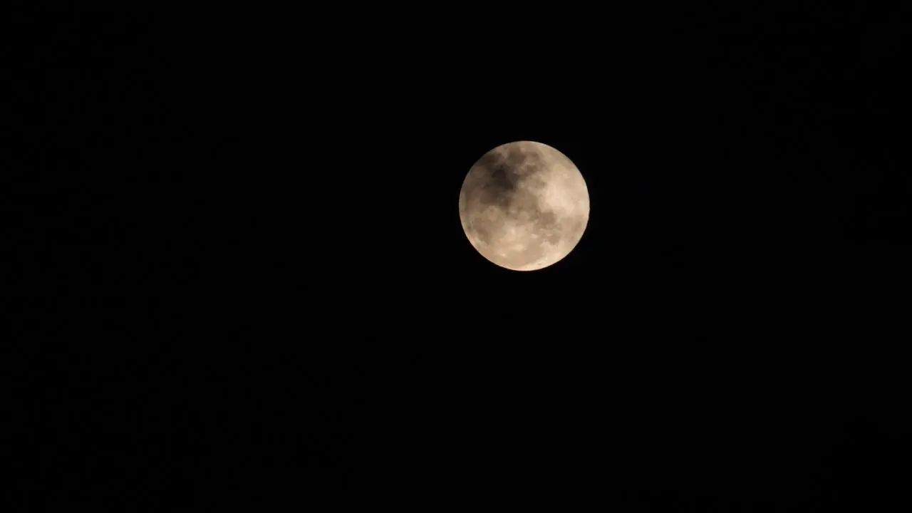 full moon in a dark night with black clouds closeup