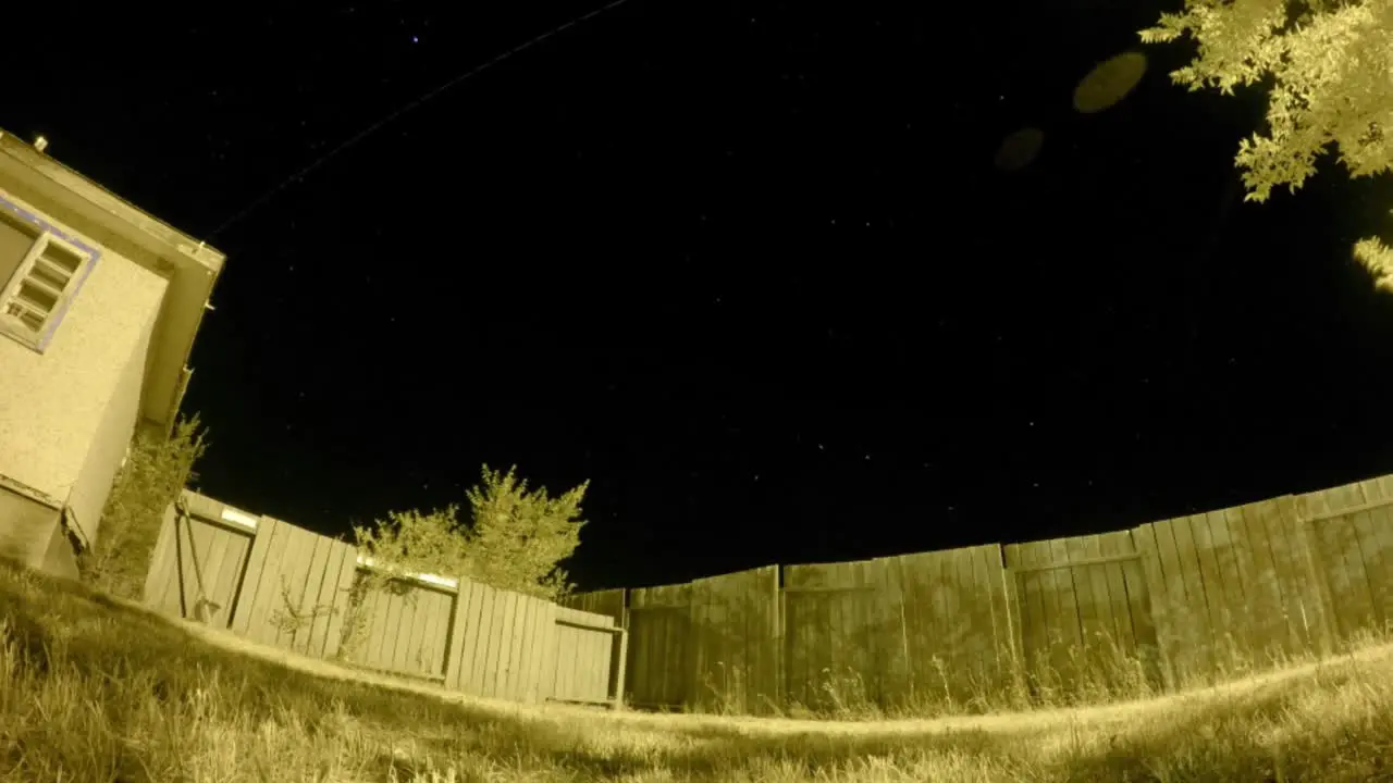 NIGHT LAPSE Beside a fence looking at the night sky in a small town in Canada