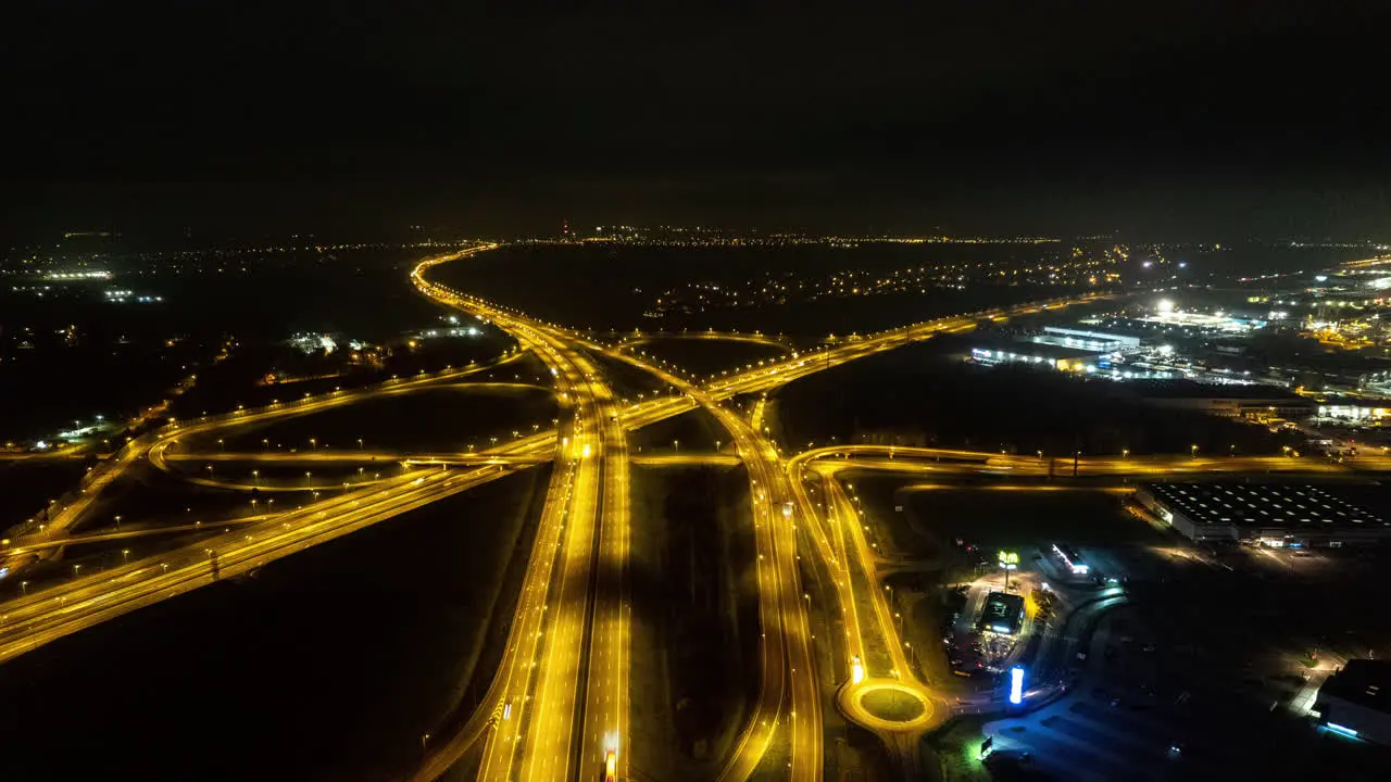 Aerial Hyperlapse of highway intersection at night with cars and traffic