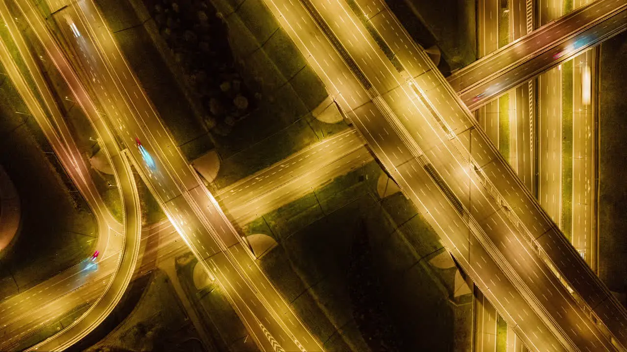 Timelapse Aerial view of a freeway intersection at night with cars and traffic