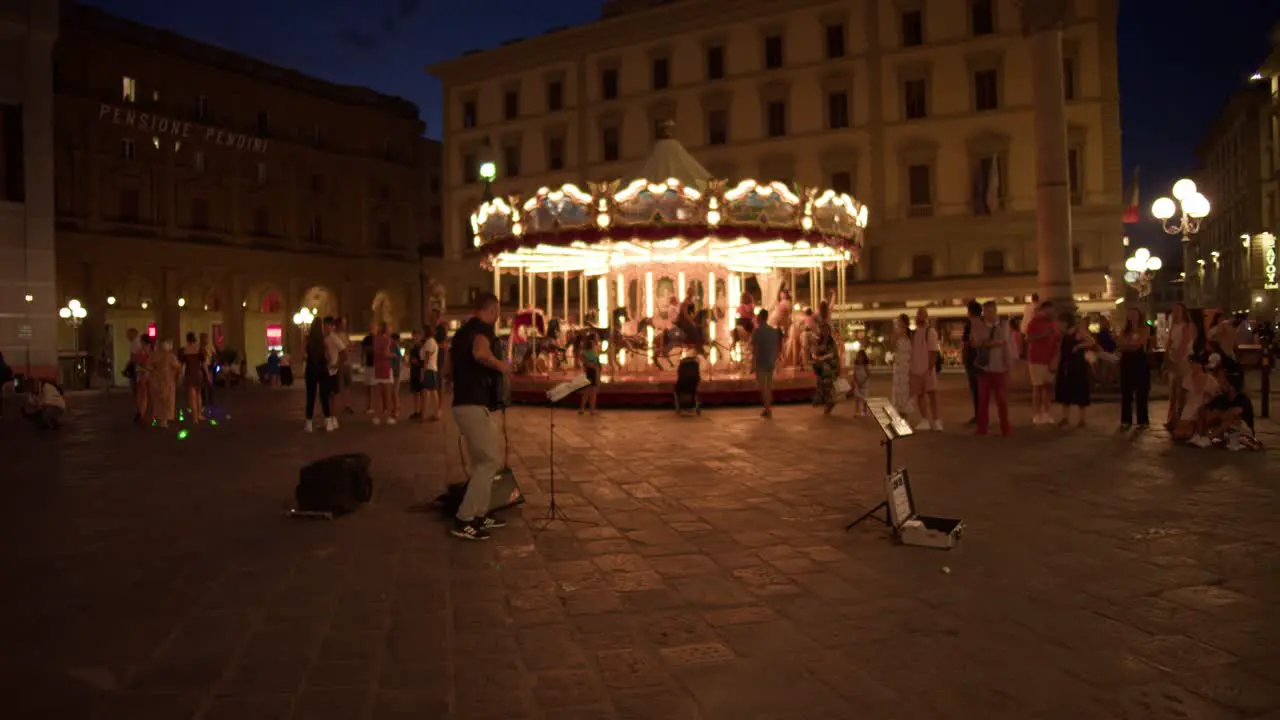 Merry Go Round Carousel and Street Performer in Florence Italy Downtown Piazza della Repubblica Active with People