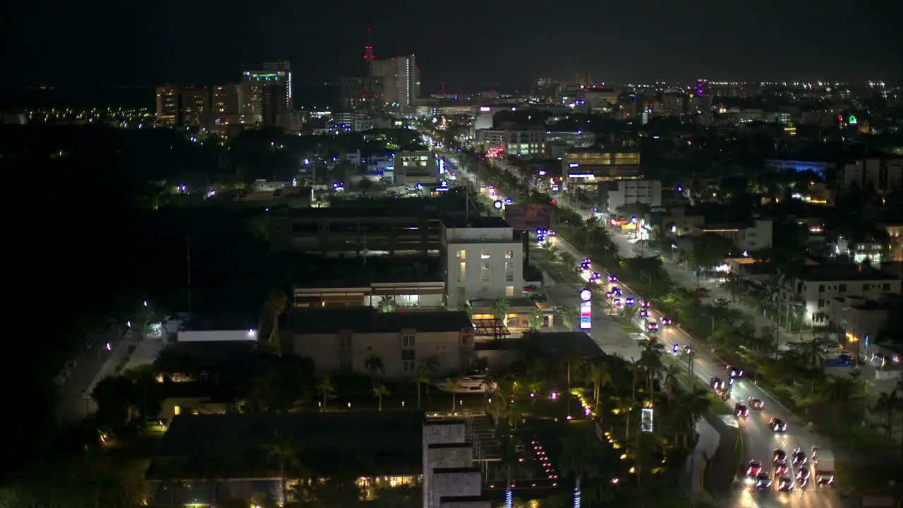 Aerial view of Cancun city at night with cars driving by on Av