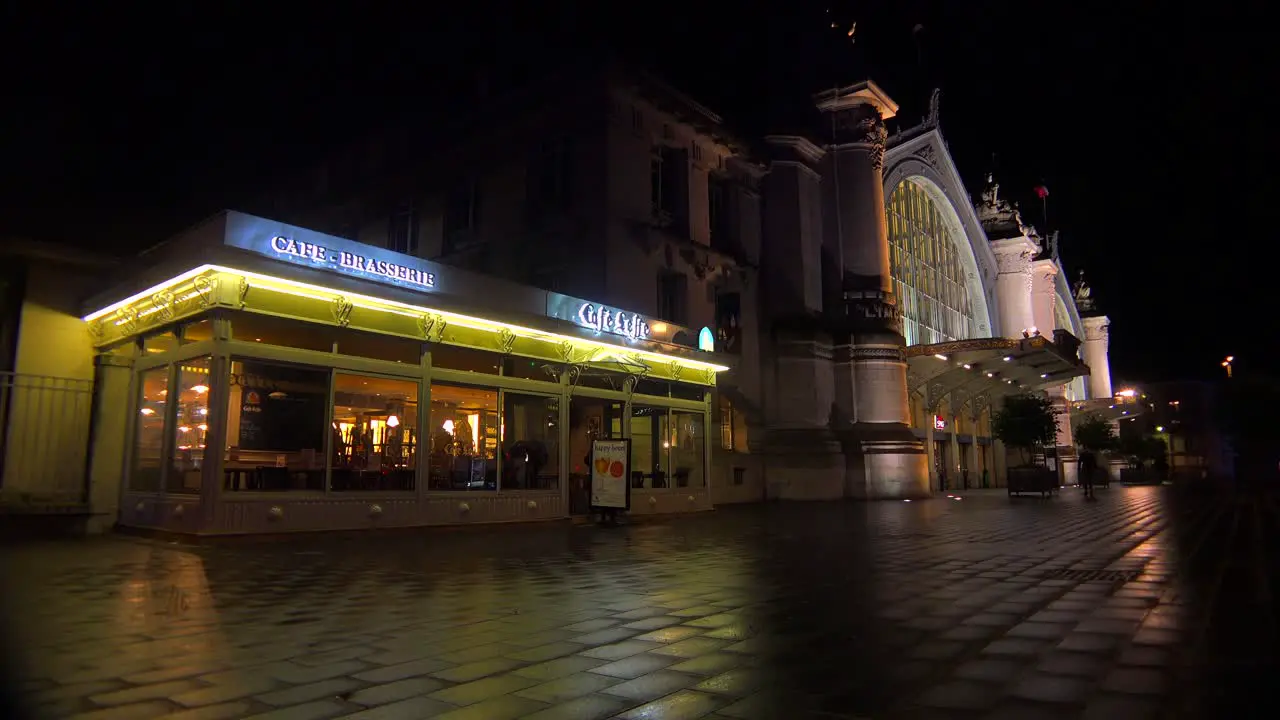 Exterior of a railway station and diner restaurant in France at night