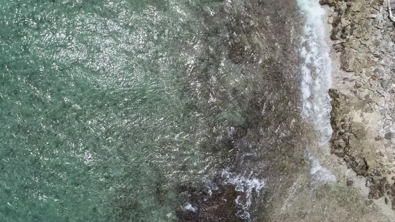 waves crashing on coastline drone view