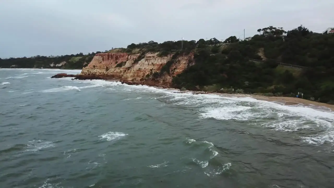 Drone aerial over ocean Melbourne wavy windy cloudy day during sunrise surf