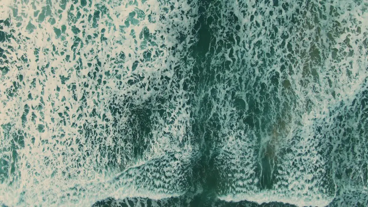 4k Aerial Waves ocean on the beach drone overhead