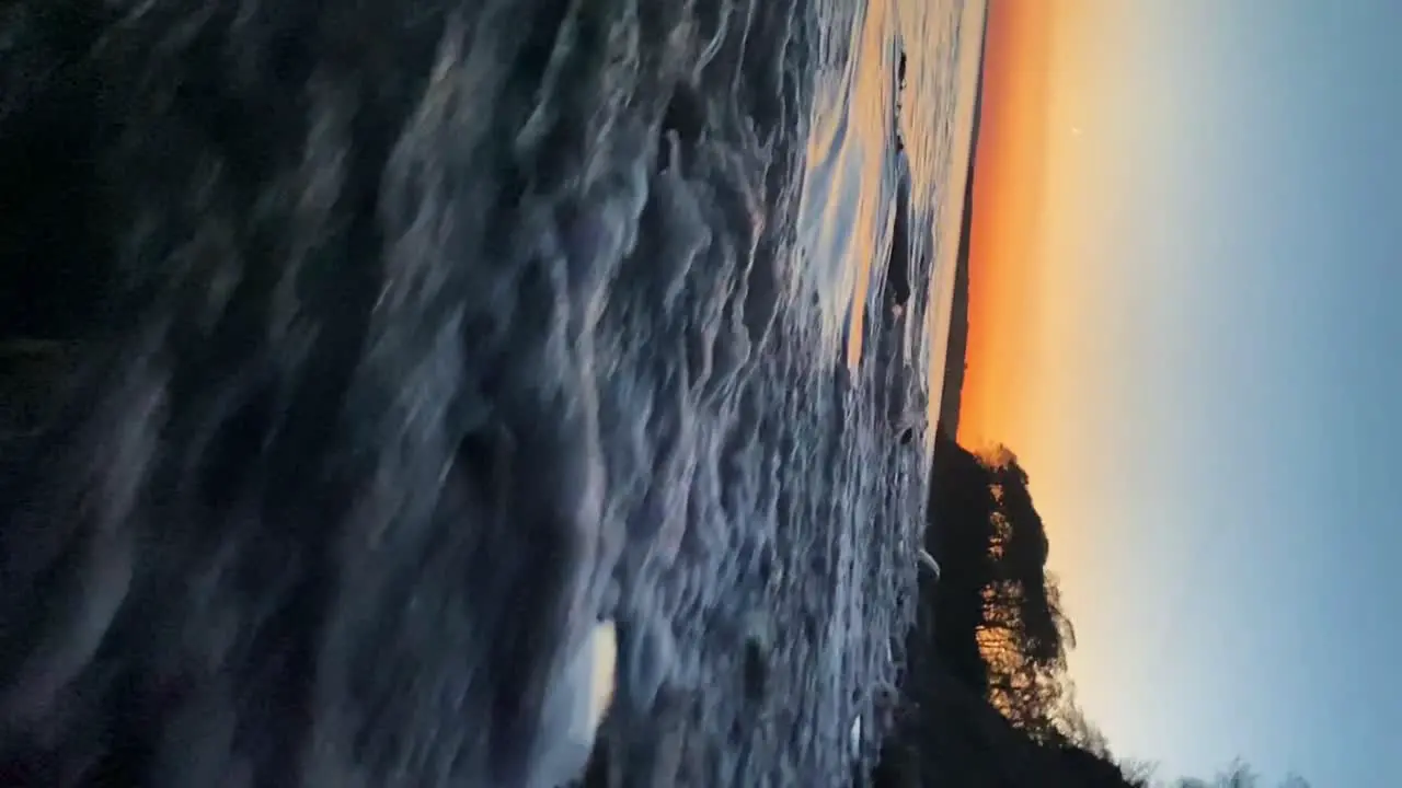 Dreamy scene seaside waves break onshore golden hour