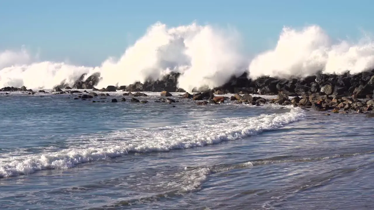 Pacific Ocean Waves Breaking on Beach and Rampart on Coastline of California USA