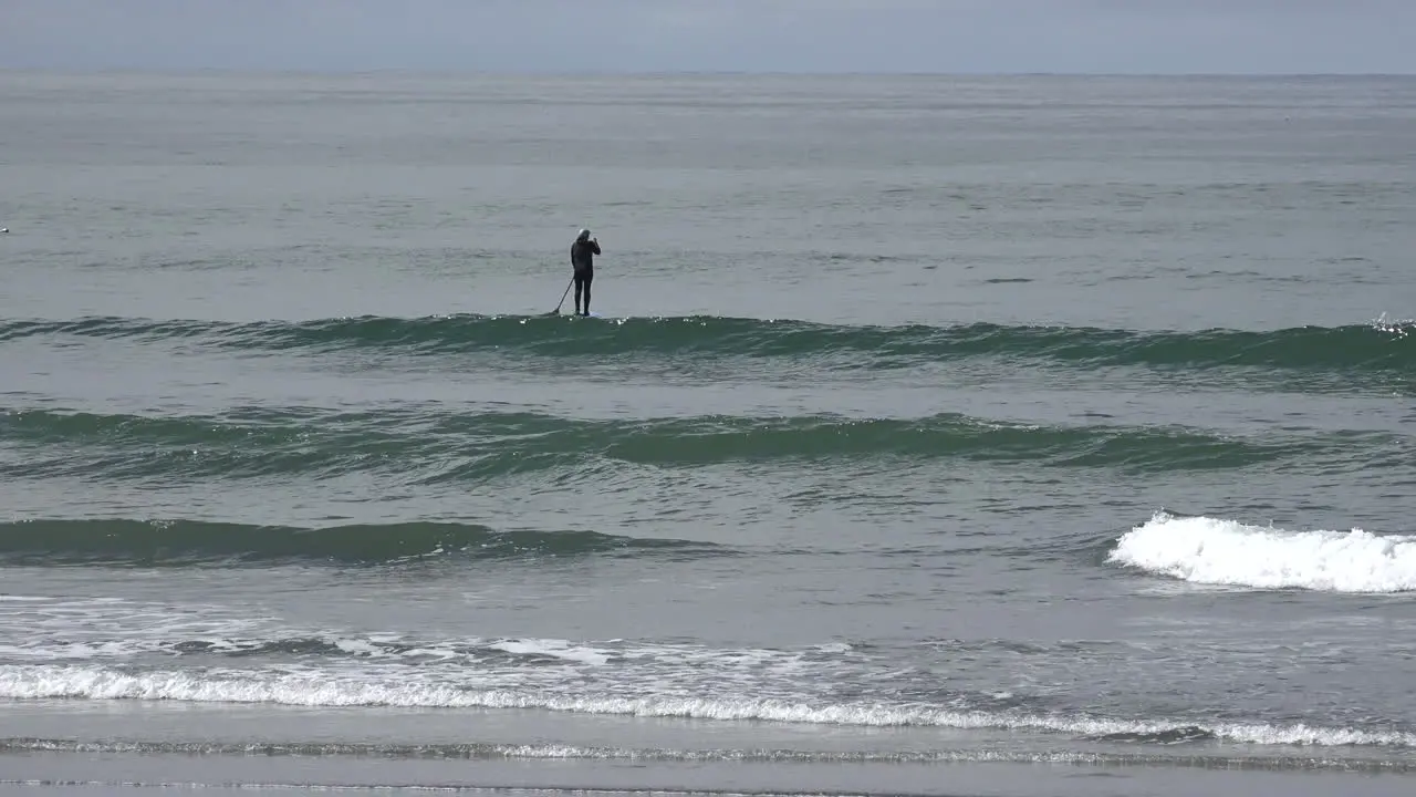 California man lifts paddle while riding paddle board