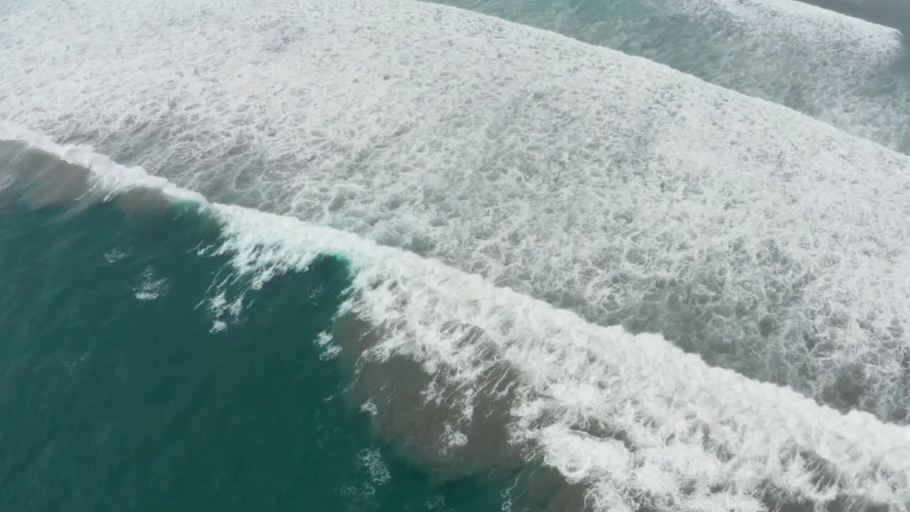 Serene Scenery or Tropical Paradise Waves Breaking on Sandy Beach Birds Eye Aerial View