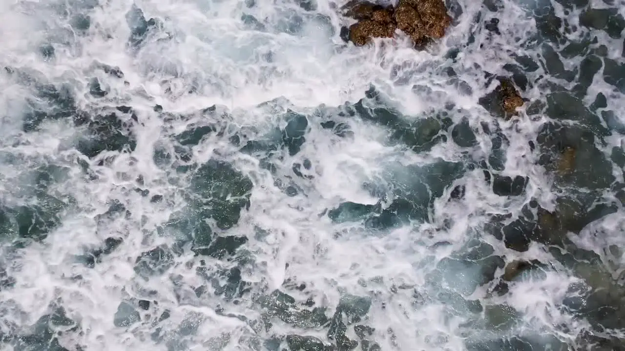 Drone footage of crystal clear blue water and waves on the shore of beach in Cebu Philippines-2