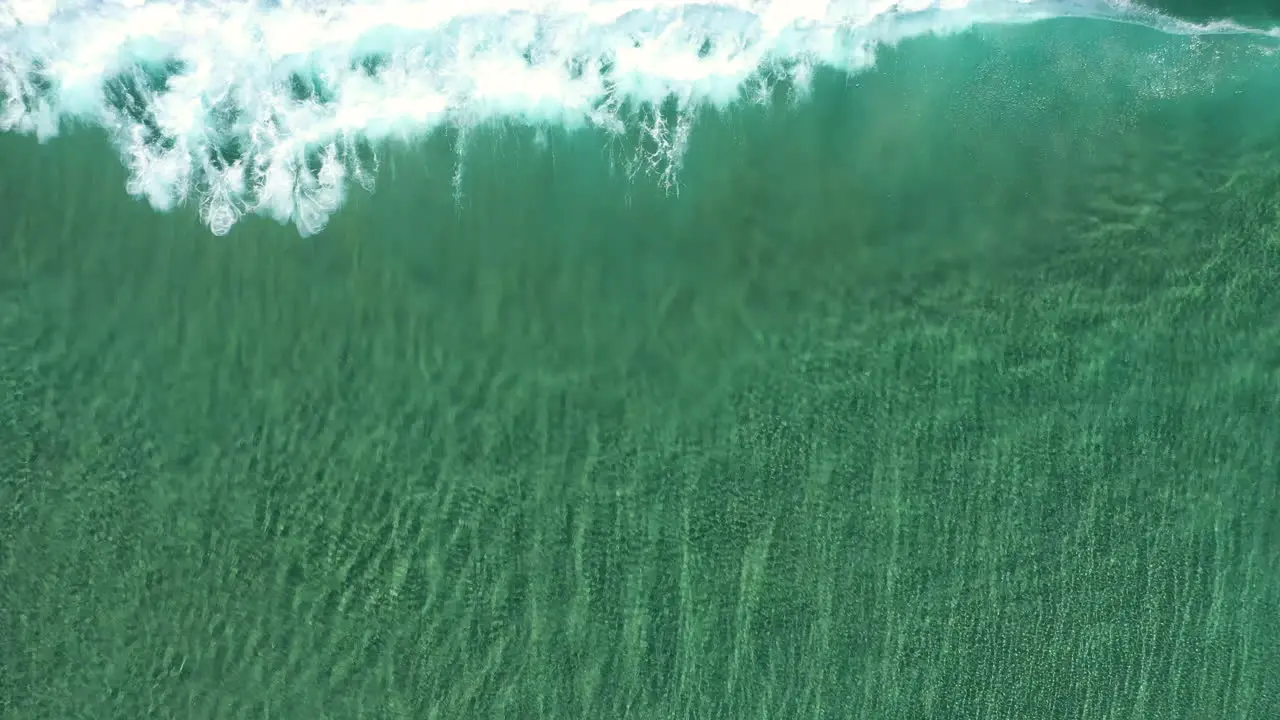 4k Top view drone shot of crystal clear turquoise sea ocean and wave break