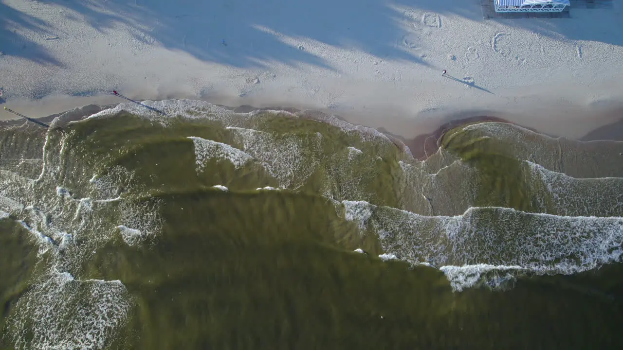 Top Down View Of Waves Splashing On Sandy