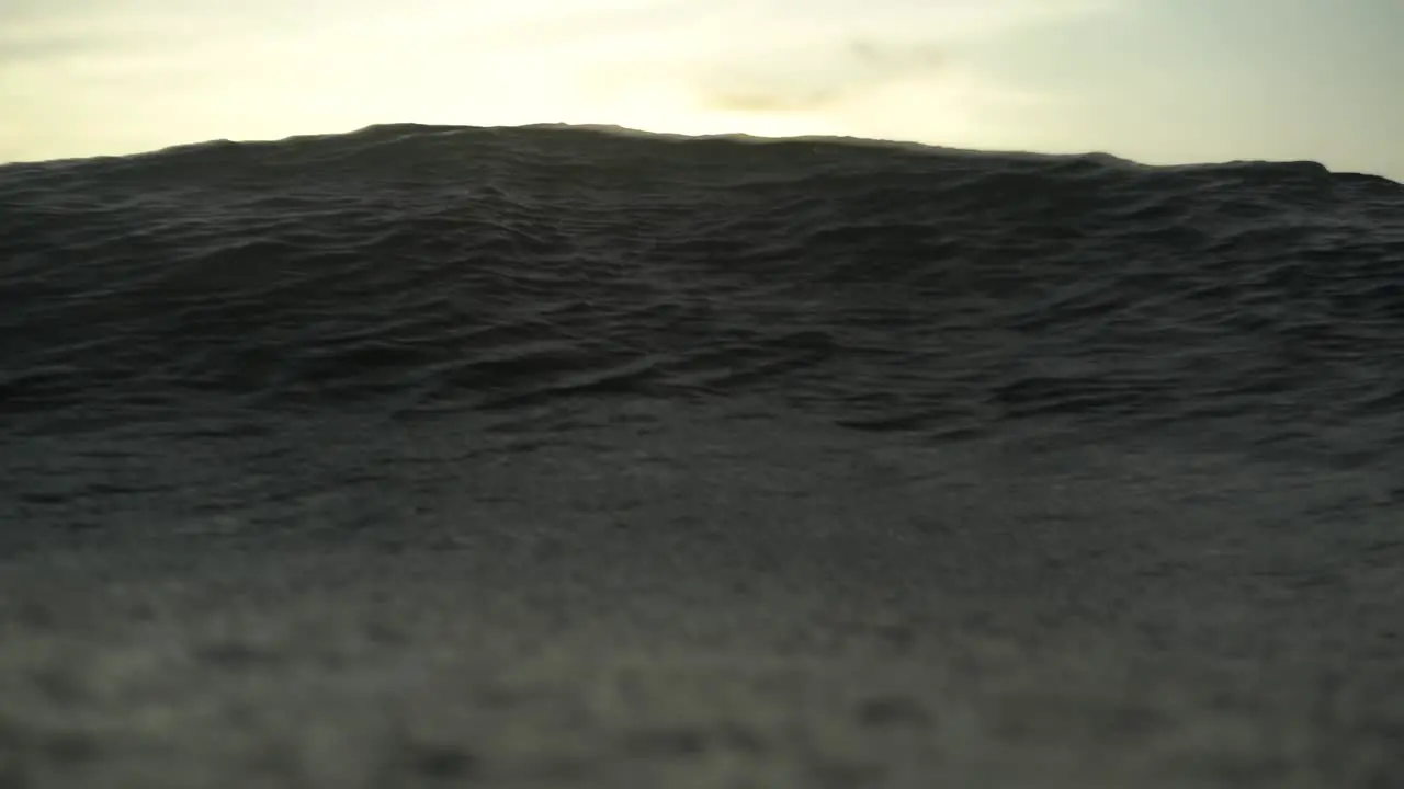 Slow motion shot ocean surface with bright flare while wave rolls over underwater Camera Indonesia