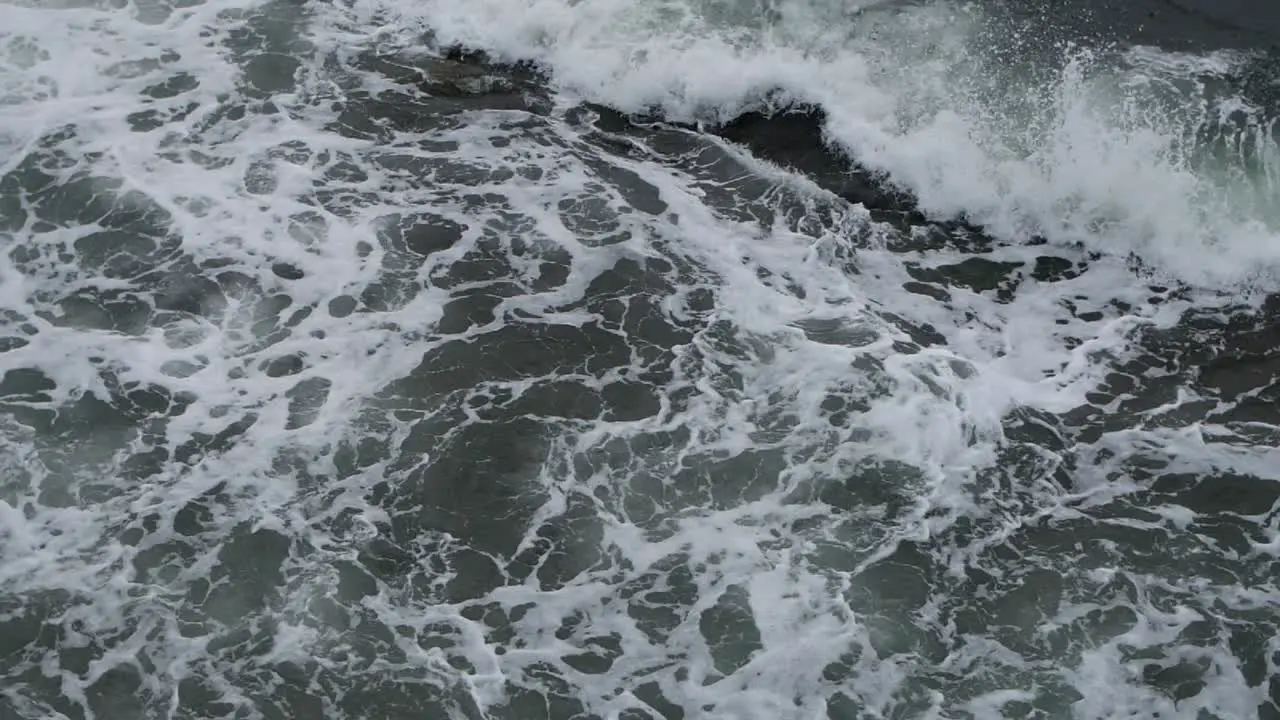 Big splash of waves on foamy sea waters wide shot in slow motion