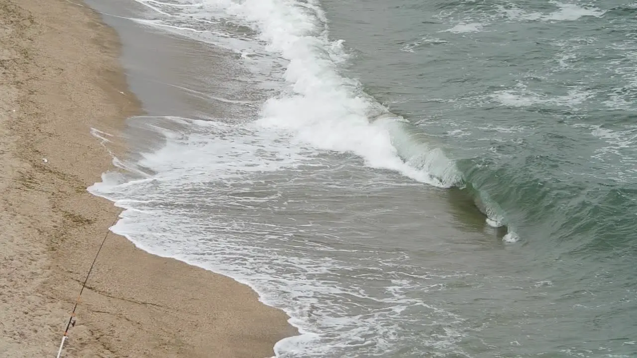 Slow motion wave in tight shot with panning up