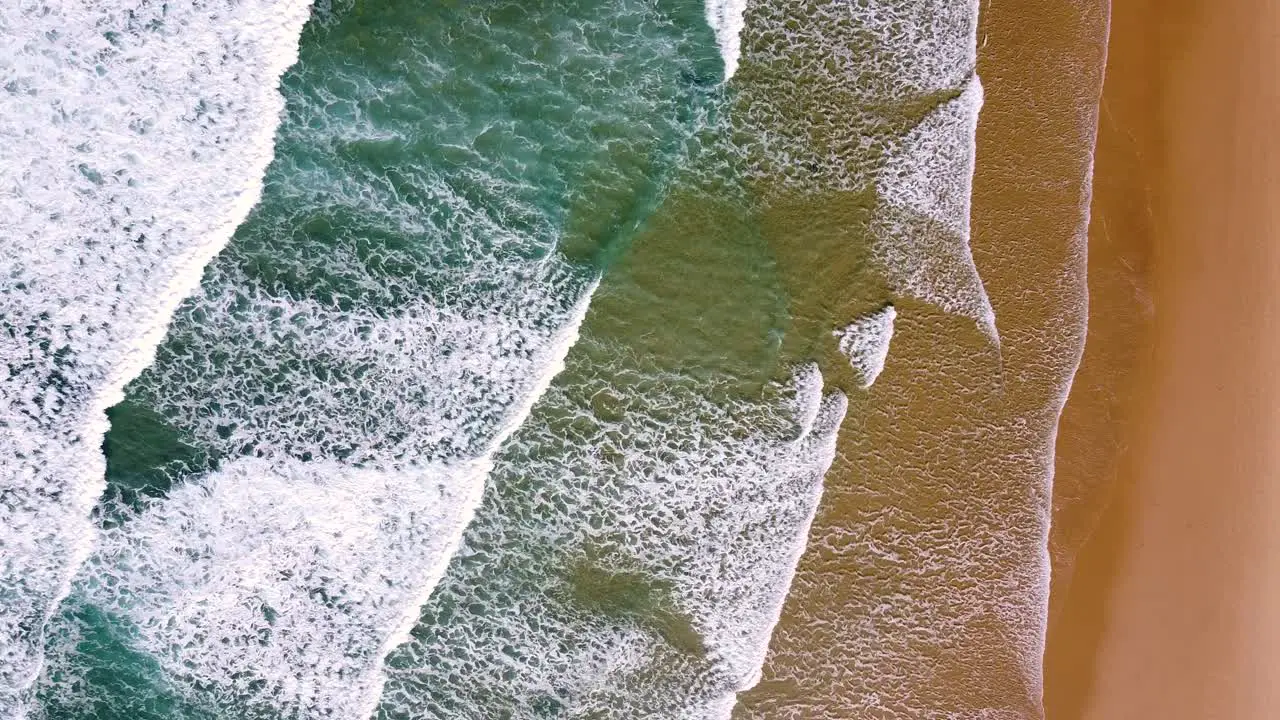 Waves slowly breaking on the coast of Algarve Portugal