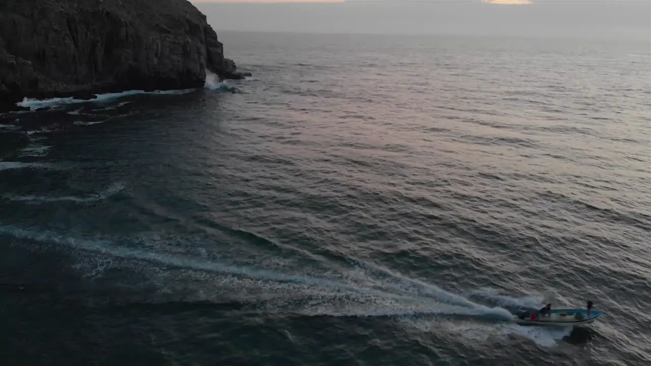 Small boat takes off into sunset 4k drone shot