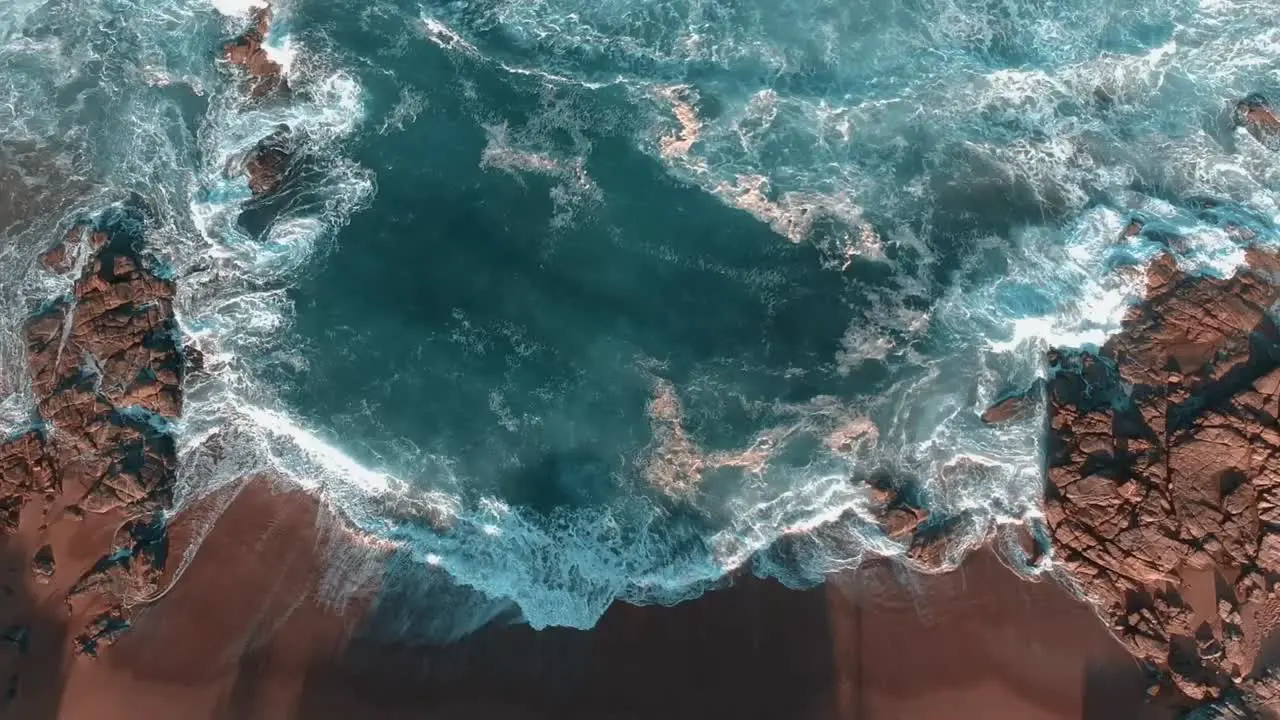 Coastal afternoon drone shot over the ocean stationary view of waves