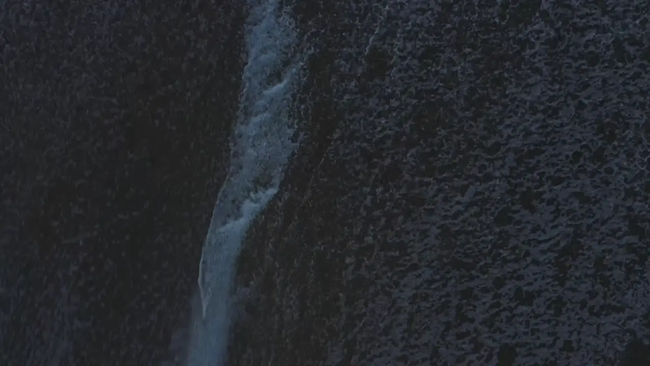 Aerial View Of Waves Crashing And Foaming On A Beach