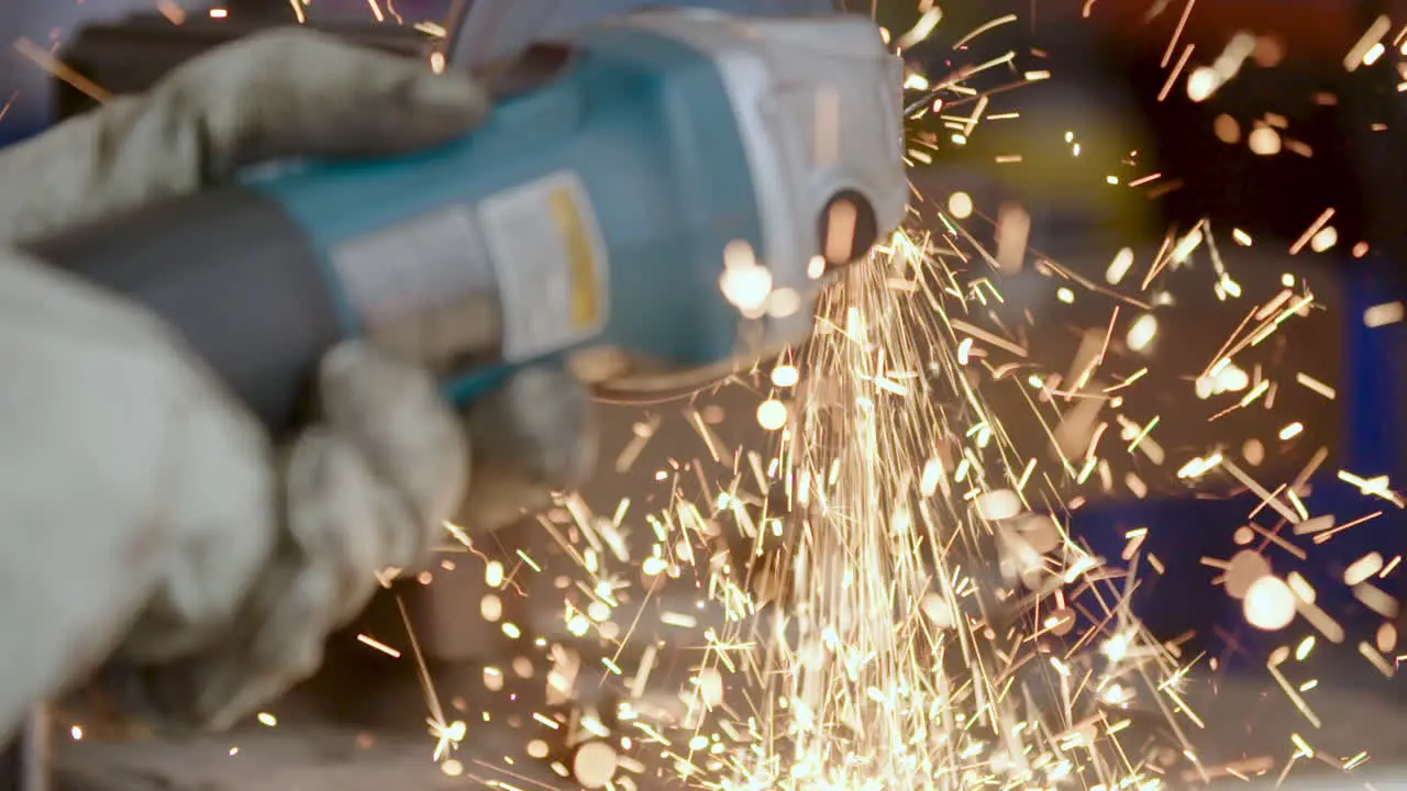 Worker Cutting Iron With Slow Motion Sparks