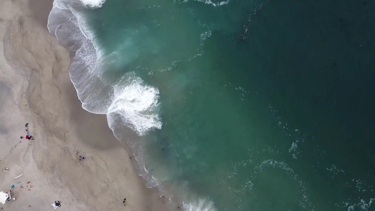 Top-down shot of green and white waves on Laguna beach