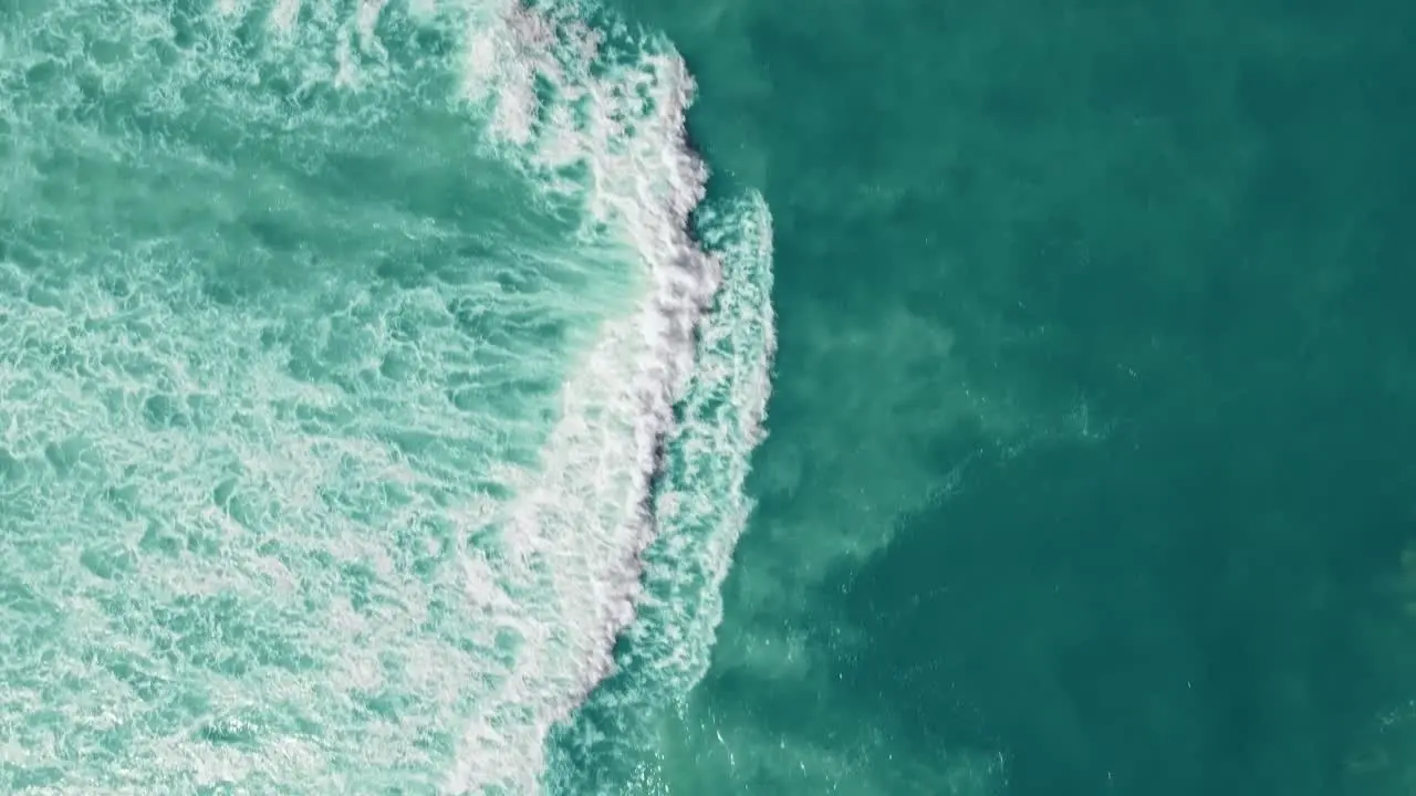 Drone view of the ocean with waves crashing