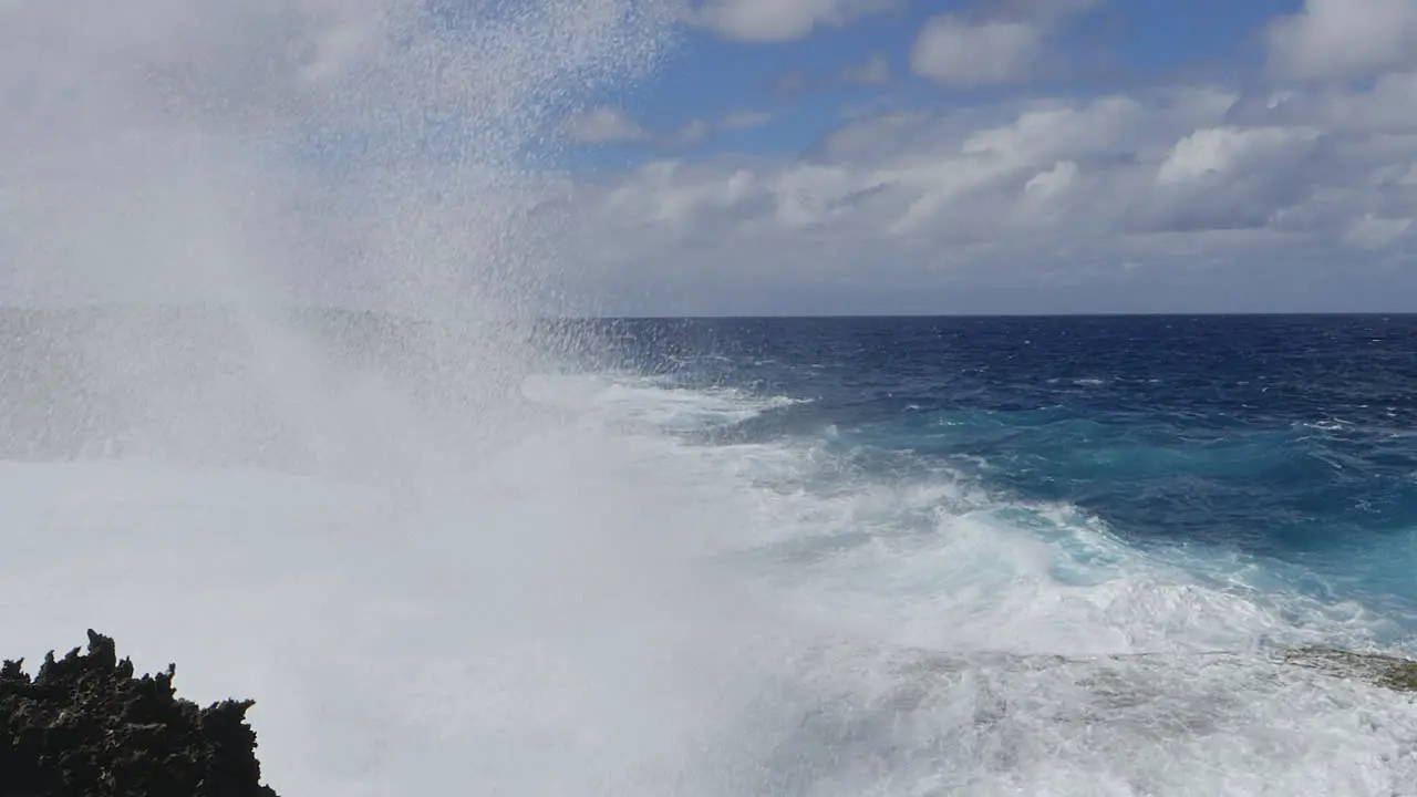 Large waves crashing against rocky Pacific island cliffs powerful ocean swell