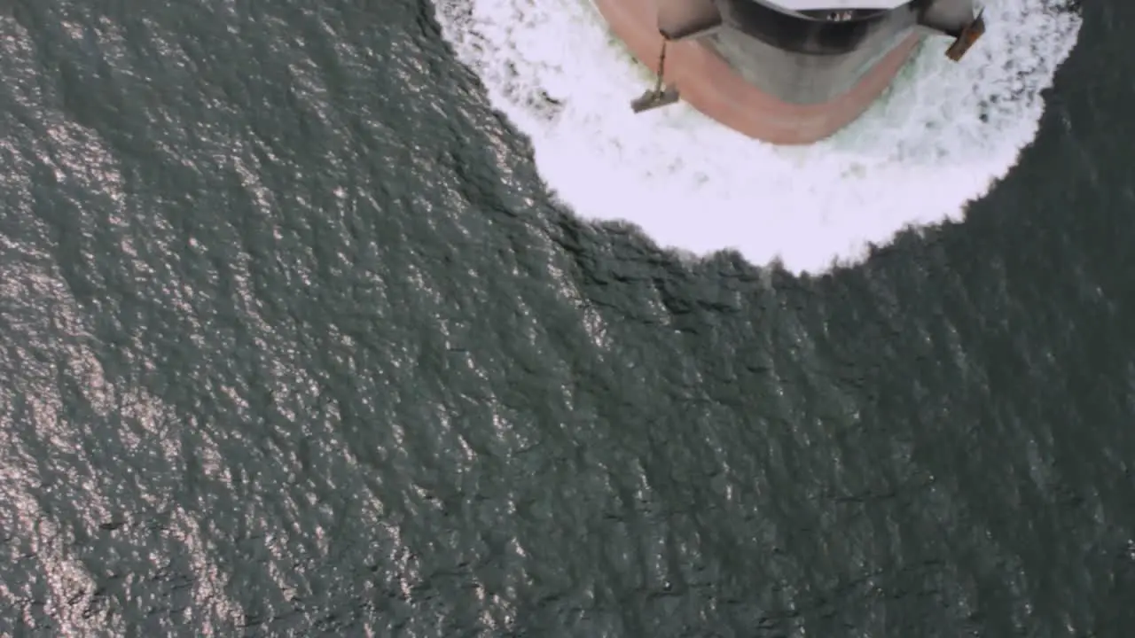 Overhead view of an empty oil tanker passing under a bridge into a harbour