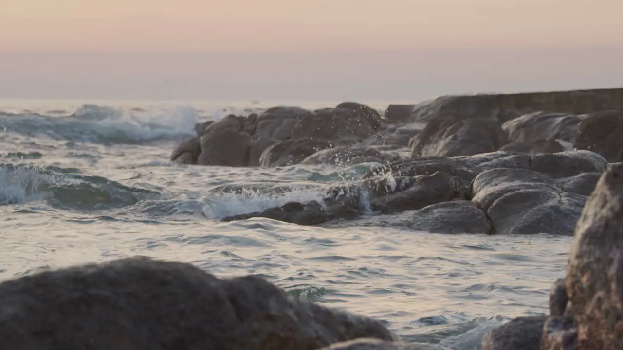 Water splashes on rocks during sunset on a beach in Portugal 2