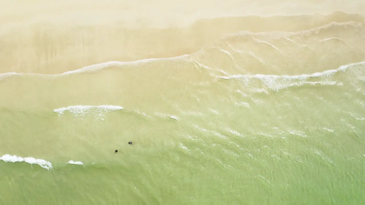 Drone top down shot of plain beach and calm sea waves