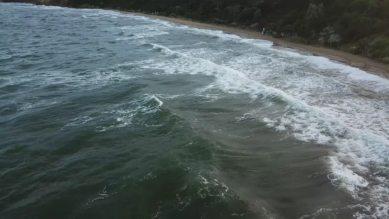 Drone aerial over ocean during a windy swimming person