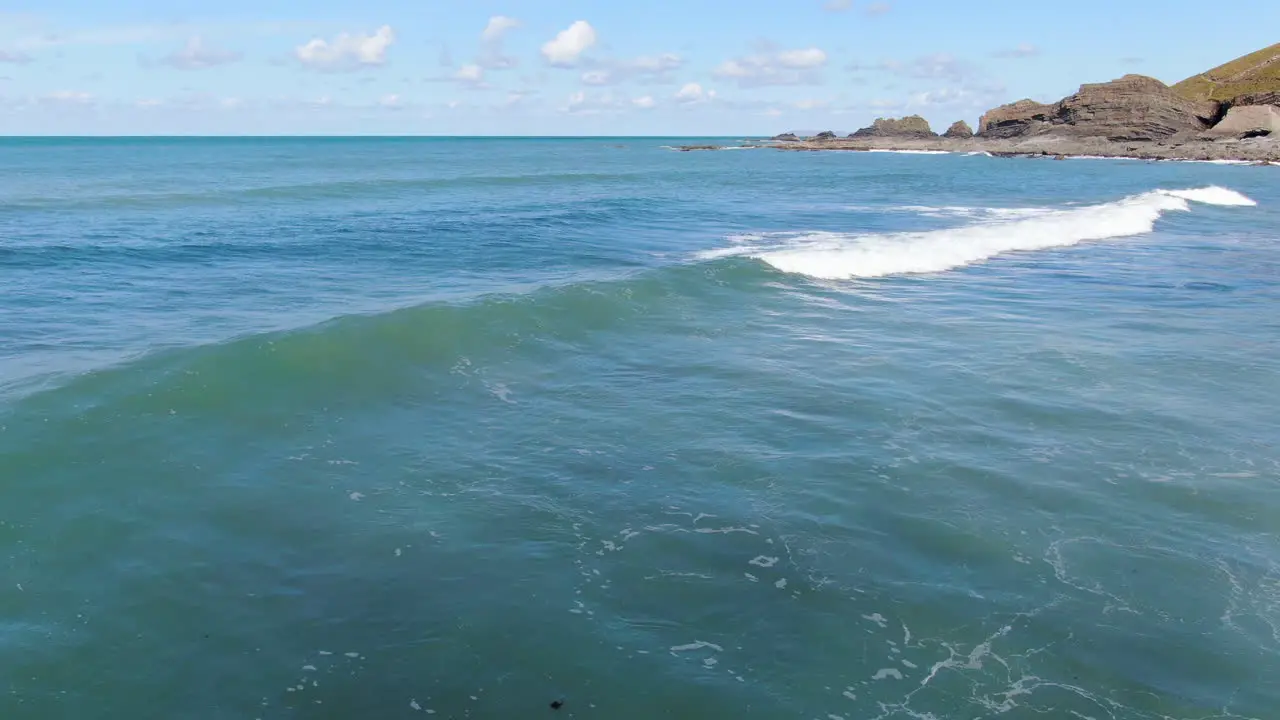 Aerial shot of the waves in the see at Spekes Mill coastal beach in Devon