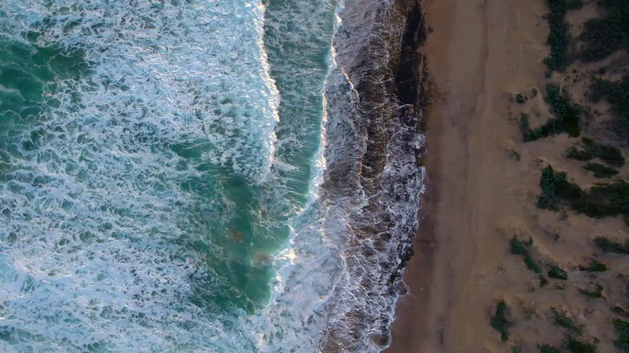 Vertical drone footage moving from the beach to the ocrean at Barwon Heads Victoria Australia