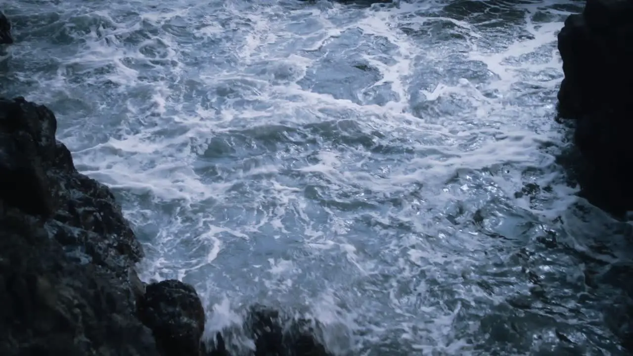 Waves and water moving between rocks on a tropical coastline