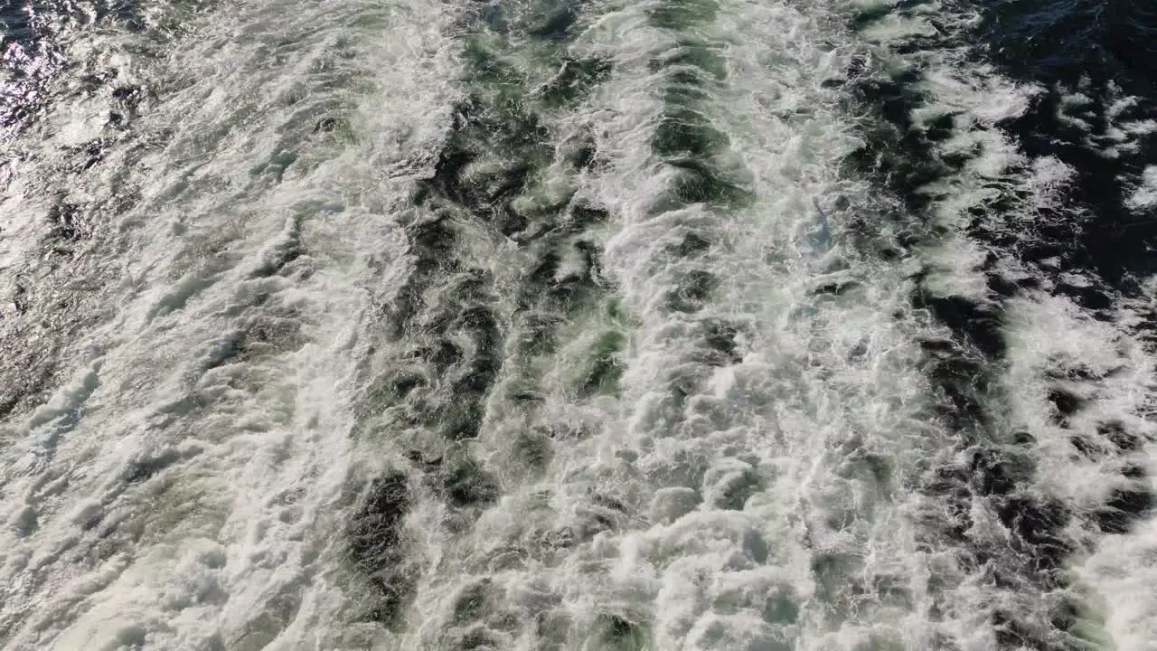 Top-down view of water flowing in the sea after the big boat ferry