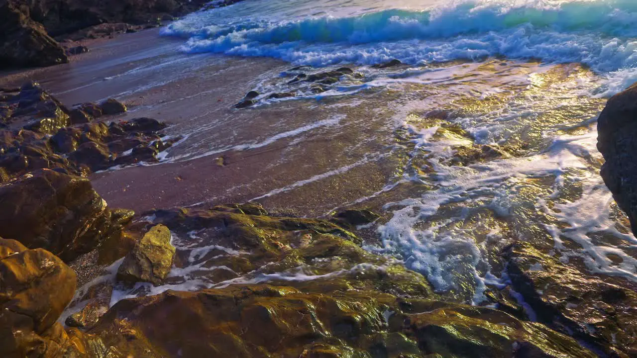 High angle slow motion ocean waves at a rocky beach