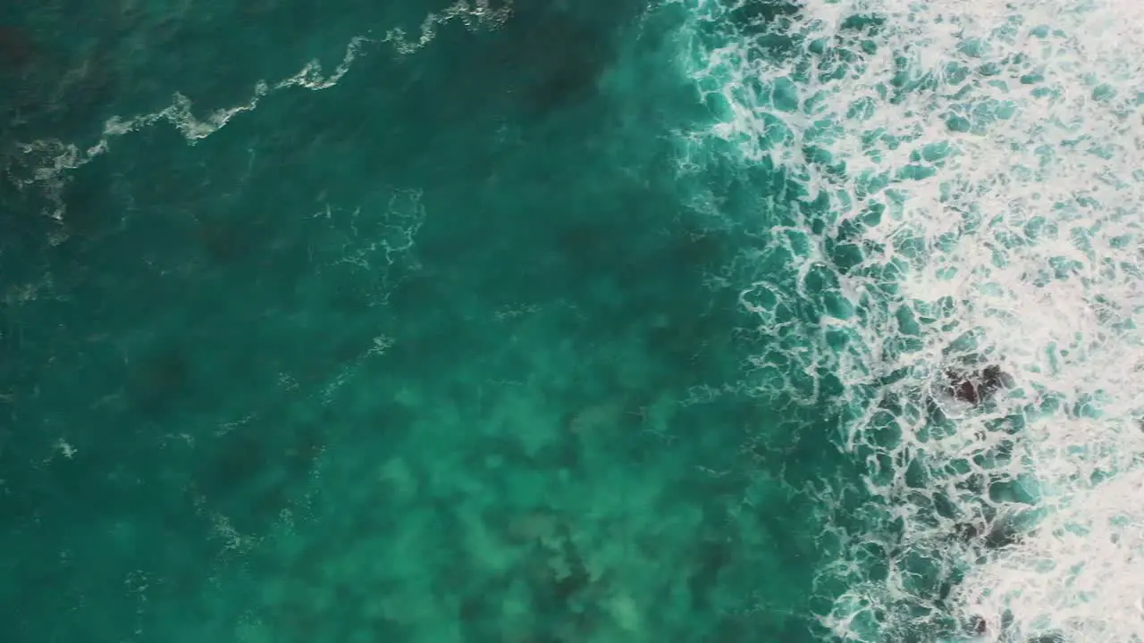 Aerial shot of turquoise ocean waves crashing coastline of Nusa penida island one of the tourist attractions of Bali island Crystal beach kelingking beach angle billabong broken beach