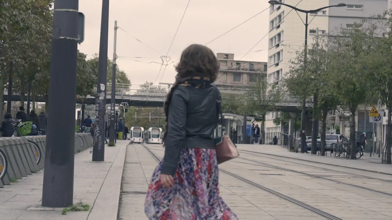 Slow Motion Shot of a Woman Crossing Tramway Rails In Vincennes France